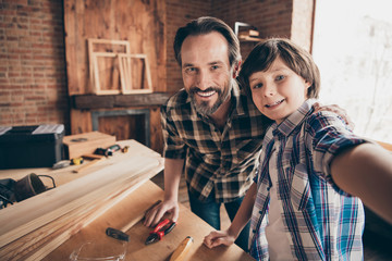 Self-portrait of two nice person cheerful cheery woodworkers handymen generation creating...