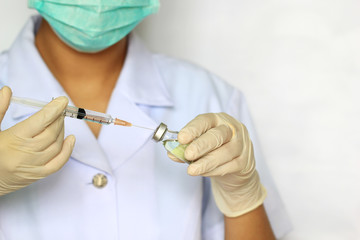 Doctor hand holding draw syringe and medicine bottle on white background, Medicine concept