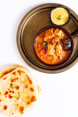 Food concept homemade Tandoori Chicken Masala curry with naan bread and yogurt dipping sauce with copy space