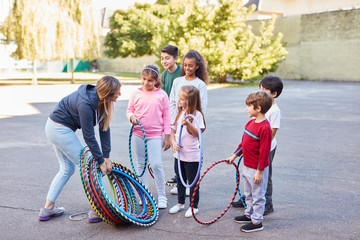 Children in summer camp with sports teacher