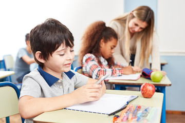Fototapeta premium Student reads or writes text messages in class