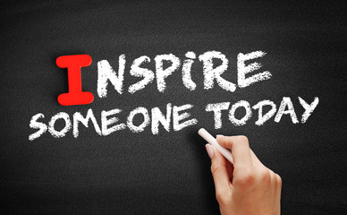 Inspire Someone Today text on blackboard, motivation concept background