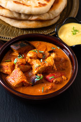 Food concept homemade Tandoori Chicken Masala curry with naan bread and yogurt dipping sauce with copy space