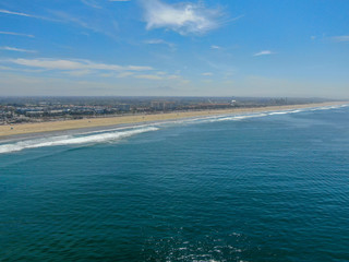 Fototapeta na wymiar Aerial view of Huntington Beach and coastline during hot blue sunny summer day, Southeast of Los Angeles. California. destination for holiday and surfer