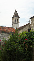 Obraz premium Stone house in the street of old town, beautiful architecture, Tower of the Church of Our Lady, Trogir, Dalmatia, Croatia