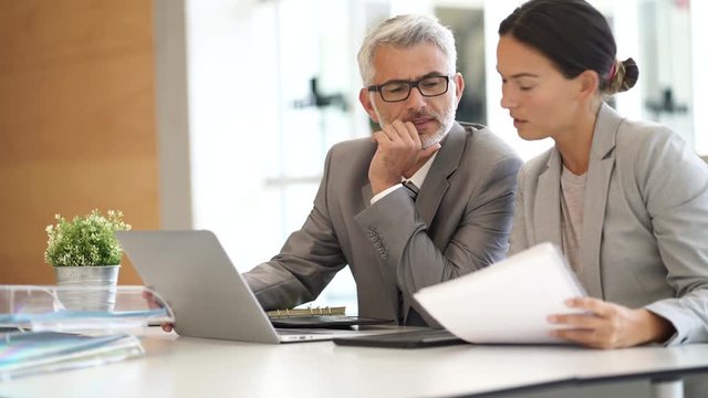 Corporate business colleagues working together in modern office
