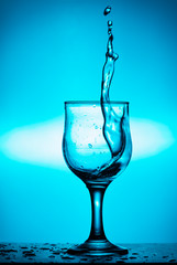 Splash of wine or water in a glass. Splash in a glass of wine. Art photo.