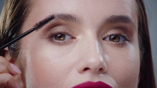 Charming eyes young woman applying mascara on eyelashes smile lashes application applying bathroom beautiful beauty black brush care cosmetic makeup close up slow motion