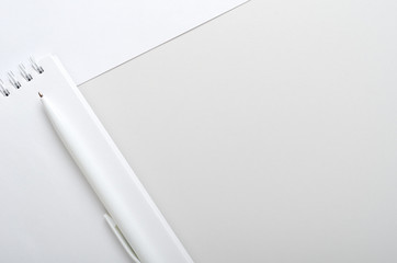 White open notebook with pen on gray and white background. Concept office desk, business. Top view, flat lay, copy space.