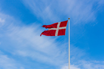 Danish flag on blue sky summer time