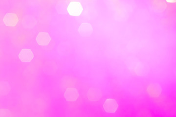 Blurred background - pink surface with gold sparkles. Abstract image. Bright color. Abstract circular bokeh.