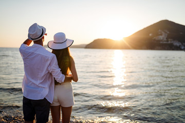 Happy young couple in love walking on seashore on vacation