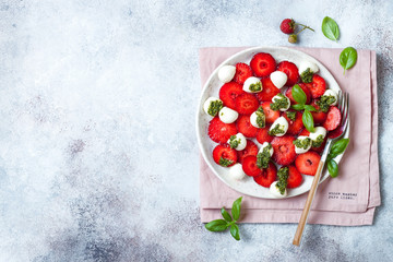 Summer fruit caprese salad with strawberries. Strawberry salad with basil pesto and mozzarella.