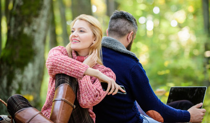 Logout of all accounts. Happy loving couple relaxing in park with mobile gadgets. Internet...