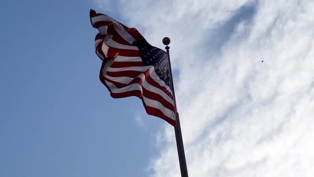 Waving american flag being blown by the wind