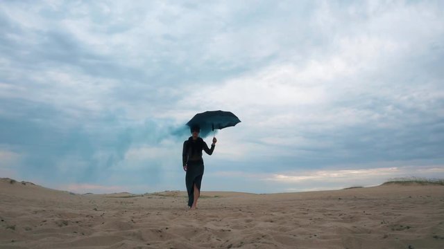 Woman walking with umbrella with blue smoke