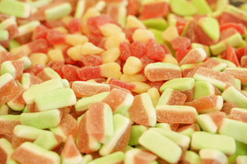 delicious multi-colored fruit marmalade. unhealthy bright candies in bulk. different jelly photo close. tasty sweets in the candy shop. nobody. 