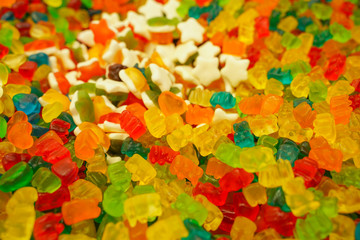 delicious multi-colored fruit marmalade. unhealthy bright candies in bulk. different jelly photo close. tasty sweets in the candy shop. nobody. 