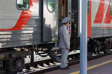 man train conductor at the car on the platform