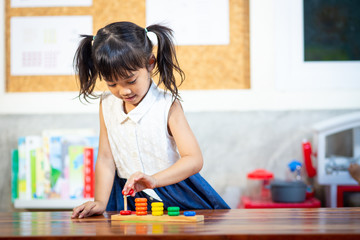 child little girl playing wooden toys