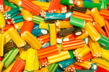 delicious multi-colored fruit marmalade. unhealthy bright candies in bulk. different jelly photo close. tasty sweets in the candy shop. nobody. 