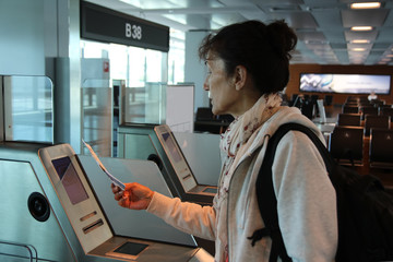 Woman check-in in a airport gate before flight