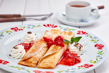 crepes with strawberry sauce and whipped cream