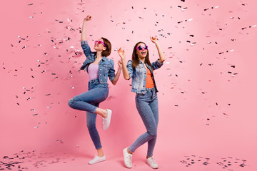 Full length body size photo beautiful she her sisters ladies festive hands raised listen playlist clubbing celebrate confetti fly fall wear jeans denim jackets blazers isolated bright pink background - obrazy, fototapety, plakaty