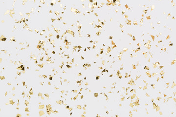 Golden confetti on white background. Festive, party or holiday glitter backdrop. Flat-lay, top view. - obrazy, fototapety, plakaty
