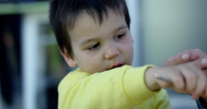 Toddler boy puts vegtable from fork onto mothers plate - picky eater - close up