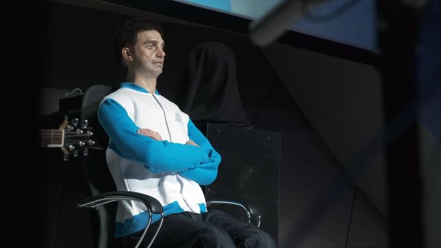Humanoid robot man on stage. Innovative development in robotics and artificial intelligence. Android Presentation. Modern Robotic Technologies. The robot shows emotions.