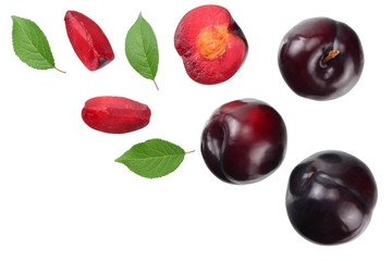 fresh plum fruit with green leaf and cut plum slices isolated on white background. top view