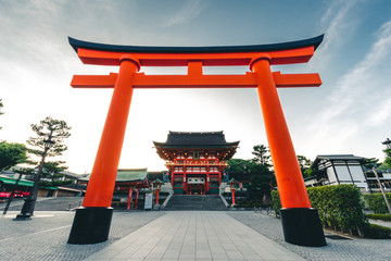 Fushimi Inari Shrine is an important Shinto shrine in southern Kyoto, Japan. It is famous for its thousands of vermilion torii gates, which straddle a network of trails behind its main buildings - obrazy, fototapety, plakaty