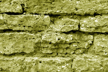 Old grungy brick wall texture in yellow tone.