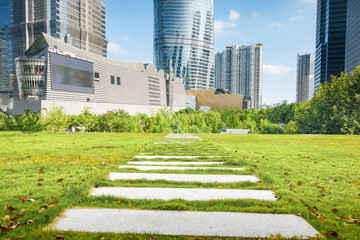 empty, modern square and skyscrapers under sunbeam