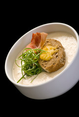 Soup puree, cream soup yellow with ham and croutons, dry bread. close up