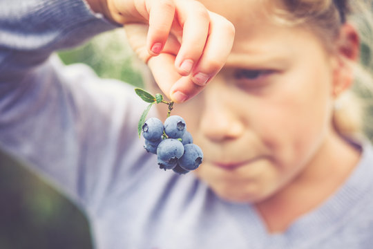  girl holding blueberries