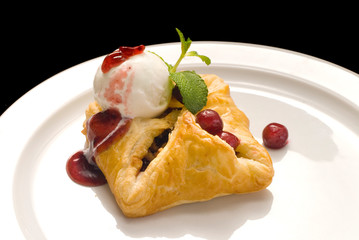 photo of delicious puff pastry with berries and ice cream on a white plate