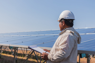 engineer checking job routine of labor working on cleaning solar panel at outside ; operation working on preventive and maintenance in solar power plant for great efficiency