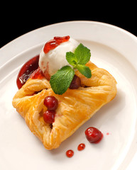photo of delicious puff pastry with berries and ice cream on a white plate