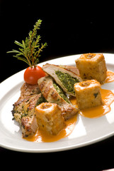 Turkey stuffed with spinach with couscous on a white plate
