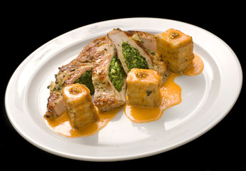 Turkey stuffed with spinach with couscous on a white plate