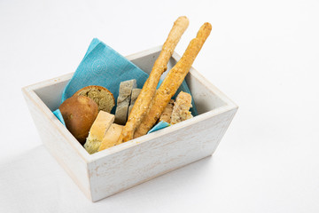Variety of freshly baked bread in a rustic wooden basket, vintage bakery and healthy food concept. Bread basket for breakfast at the hotel or restaurant