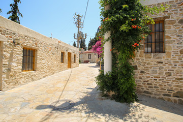 Fototapeta na wymiar Street view of Old Datca with authentic stone houses. An electric pole and wall flowers also exists in the street.