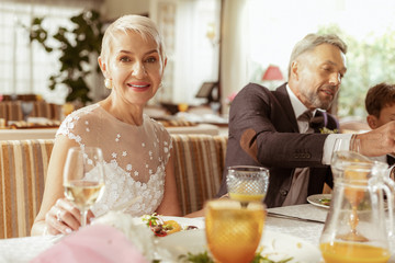 Aged couple feeling happy celebrating wedding with family