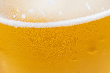 Closeup of a cold beer glass with condensation droplets on the surface