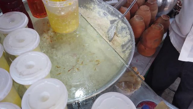 Street food- Rabri faluda, a sweet rich thick drink served with a spoon, consisting of vermicelli noodles from Indian subcontinent and Pakistan, Bangladesh.  4k 60fps close-up stabilized handheld