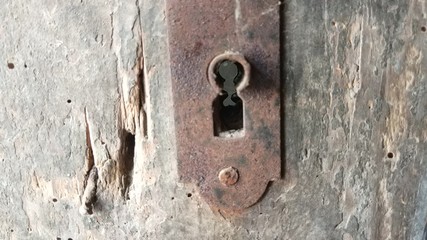 Abandoned old keyhole on the door of the house