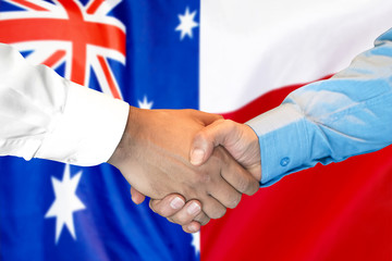 Business handshake on the background of two flags. Men handshake on the background of the Australia and Poland flag. Support concept