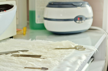 A disinfection machine in a liquid solution in beauty salon, along with manicure instruments
